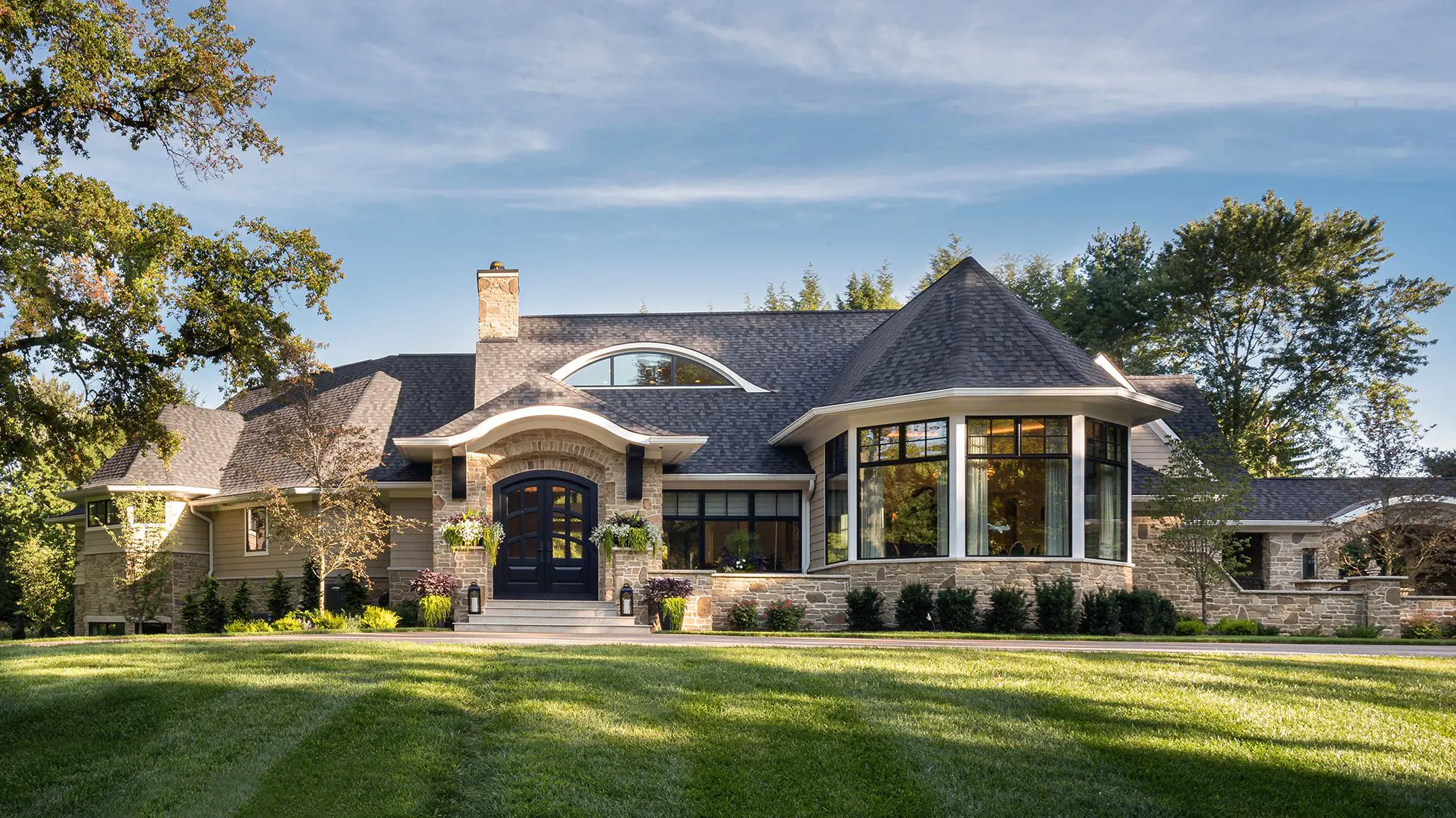 2-story custom-built home in Charlotte, NC, with shingle siding and a landscaped yard.